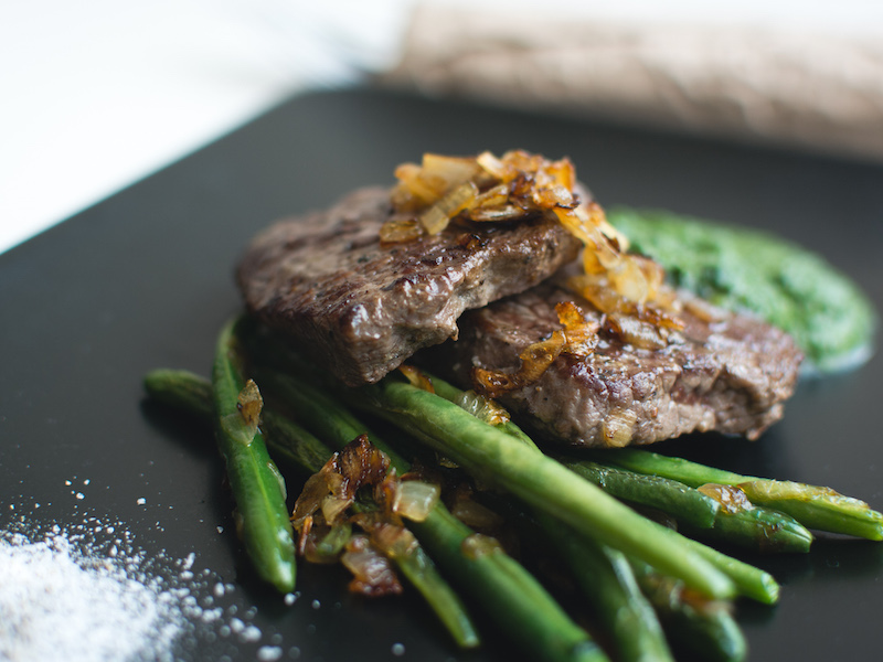 Grilled Paleo Beef Steak with steamed green beans on the side.